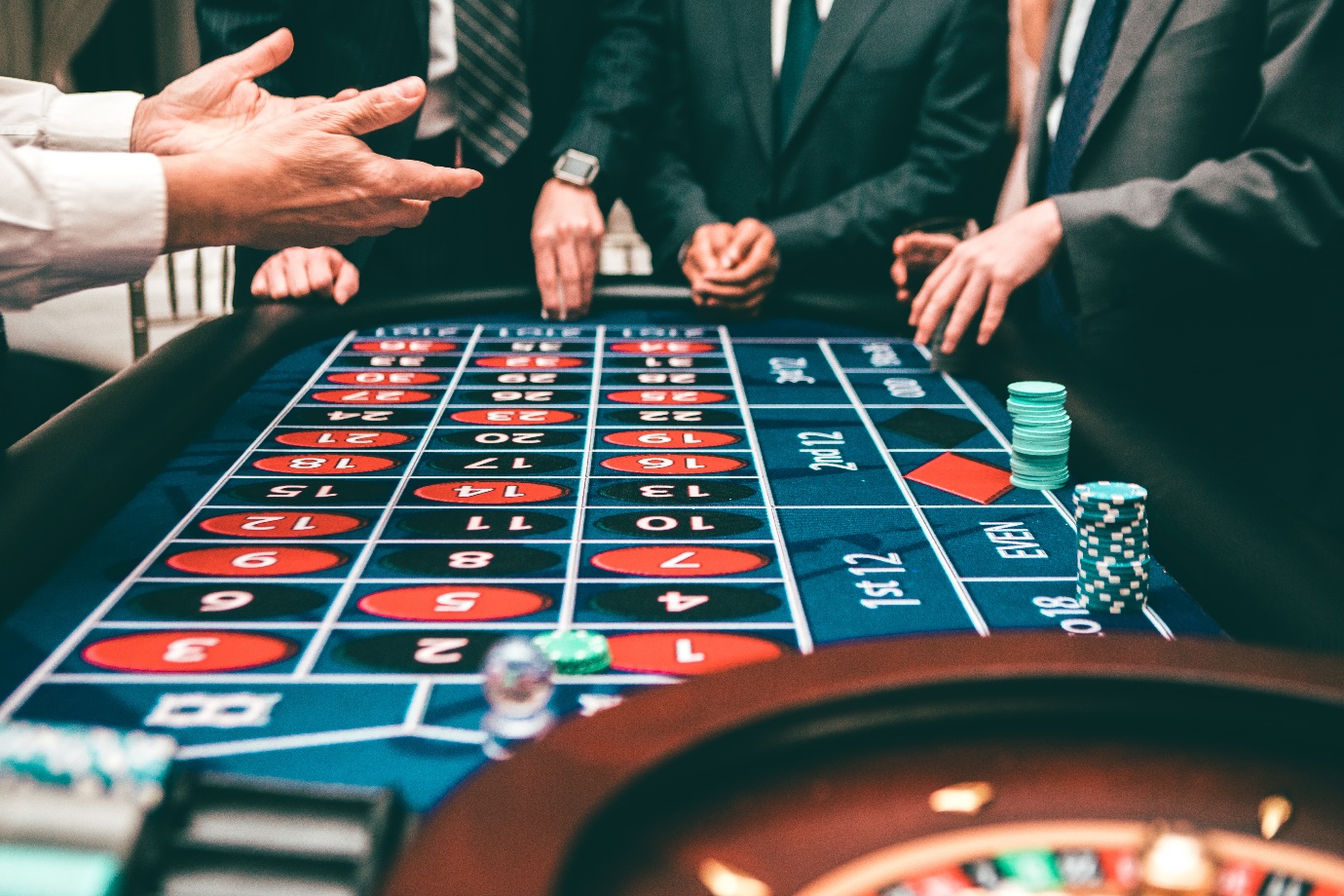 A group of people playing roulette Description automatically generated