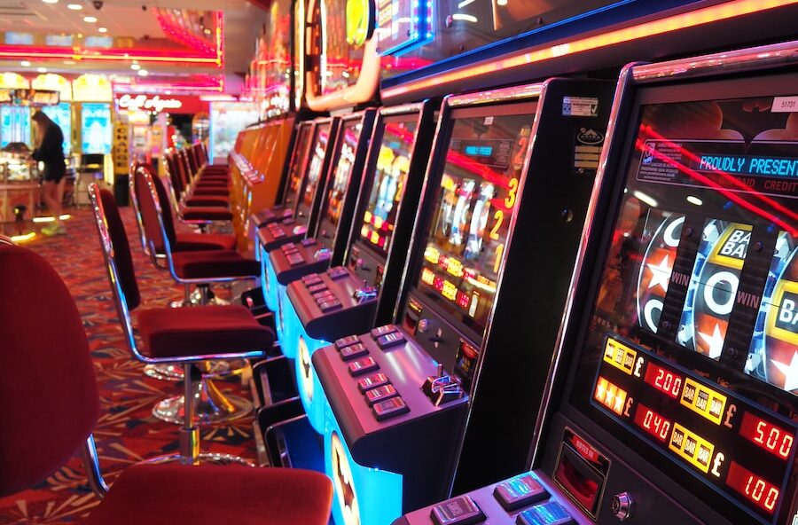 arcade machine with red and white chairs