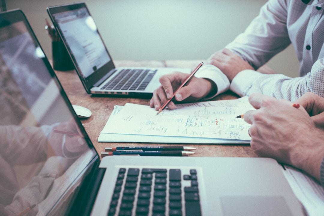 Business professionals look over data gleaned from area charts