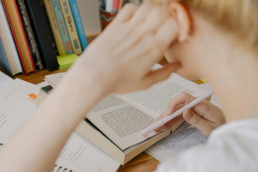 Free Child Writing on White Paper Stock Photo