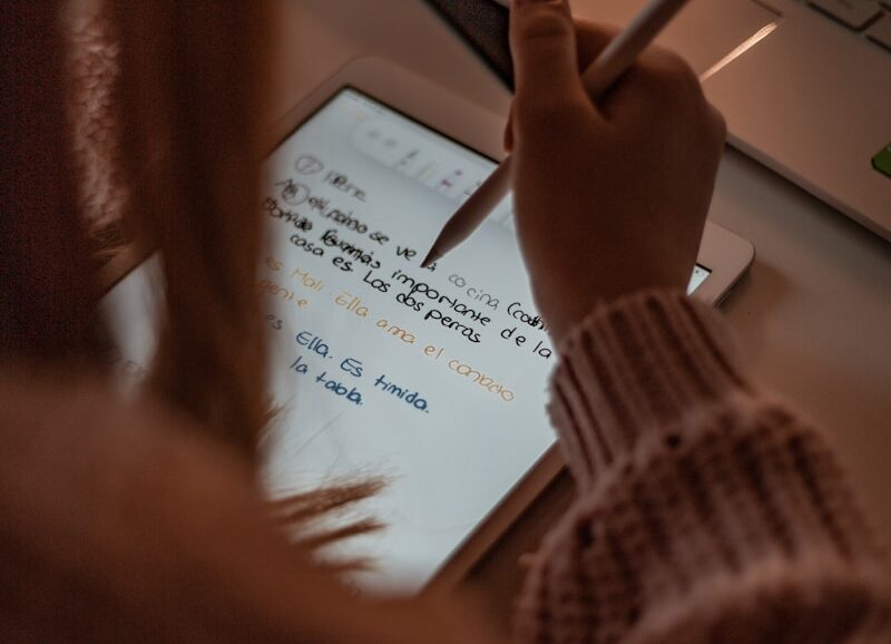 person writing on white paper